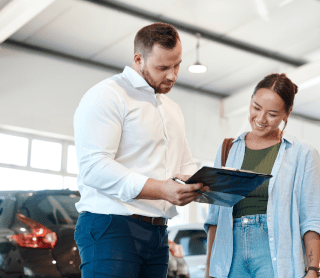 Homem e mulher num stand de automóveis