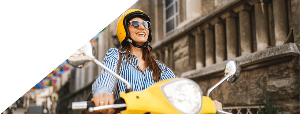 Mulher sorridente a conduzir mota amarela