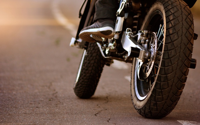 Pneus de uma moto a circular na estrada.